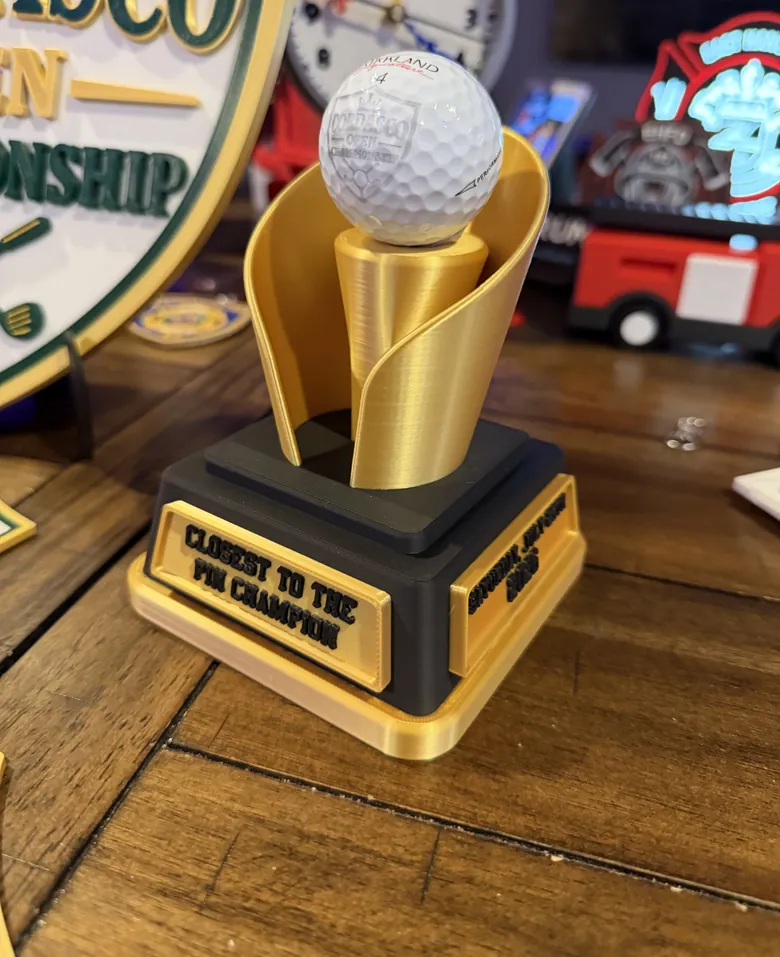 Closest to the pin champion trophy with golf ball